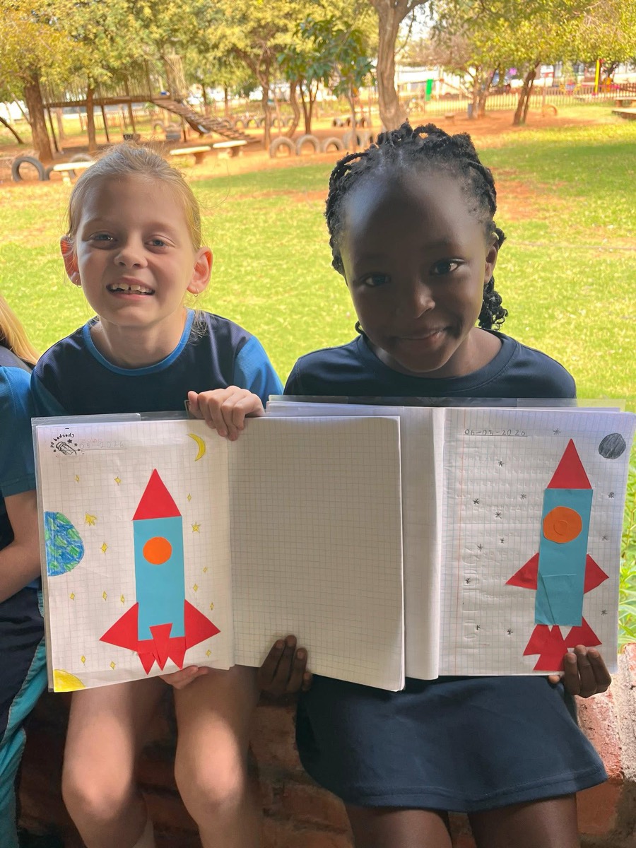 Learners showing their rocket craft projects